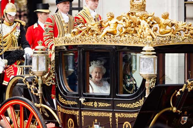 The Queen enroute to the Palace of Westminster in a hrose drawn carriage
