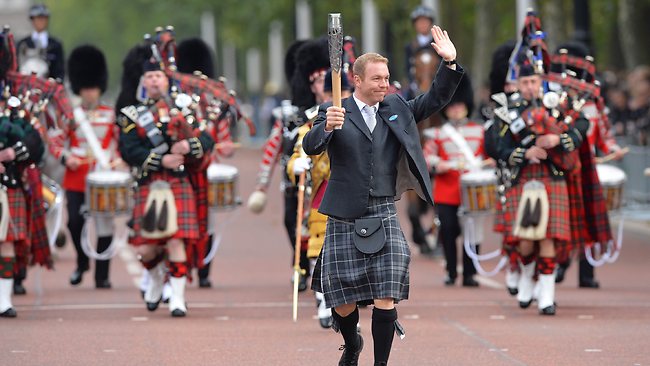 Sir Chris Hoy carries the Commonwealth Games Baton