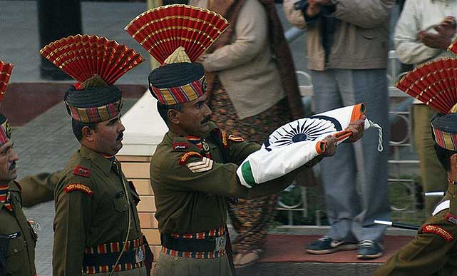 Soldiers march back with the Flag of India